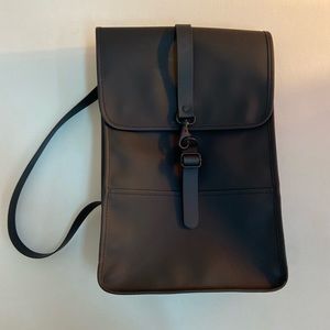 Rains black waterproof backpack in the classic silhouette